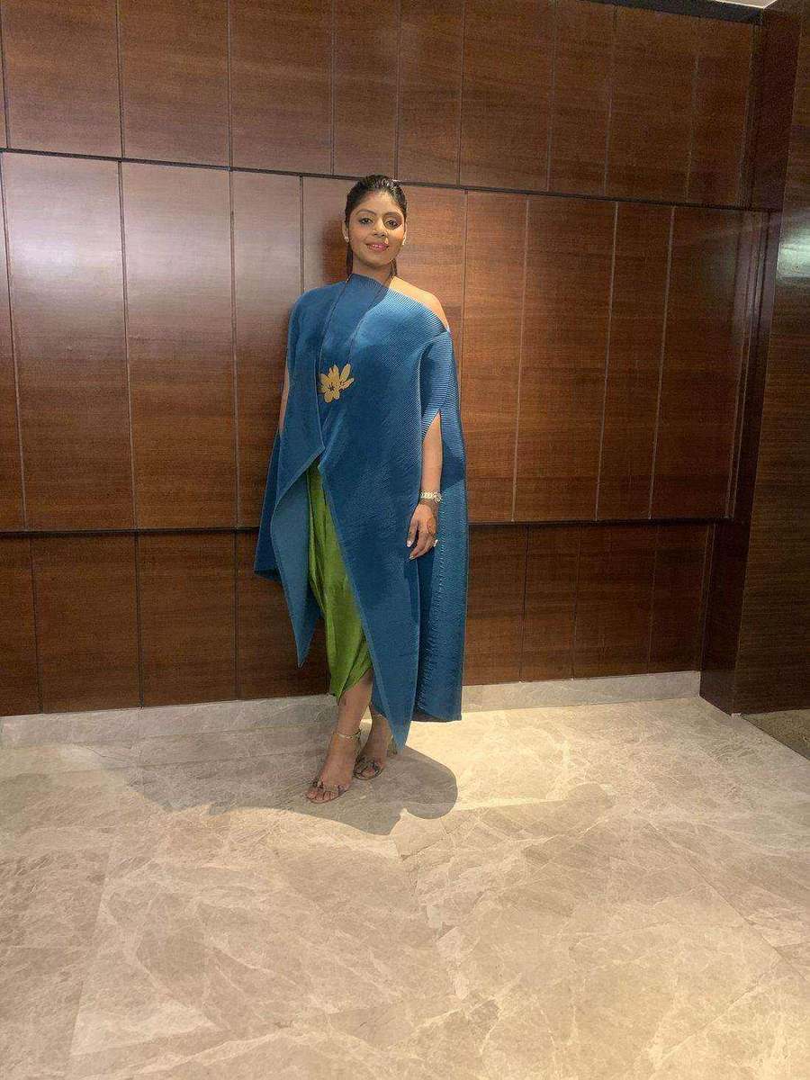 Tanya Jain in a teal pleated one-shoulder drape over a green slip