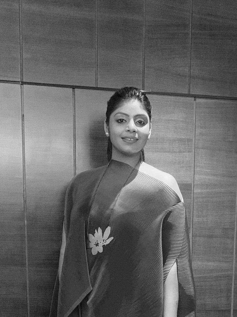 Black and white portrait of Tanya Jain in a pleated one-shoulder drape