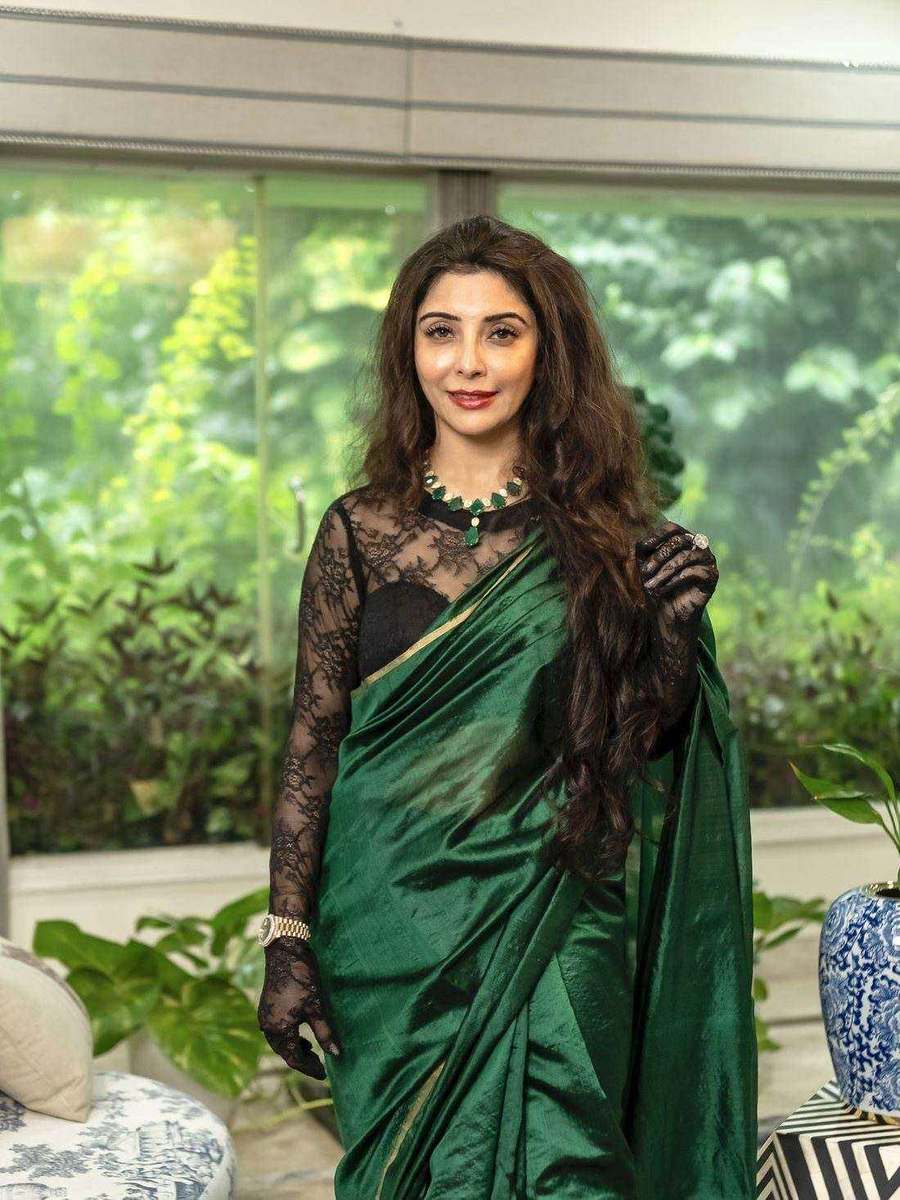 Dr. Jai Madaan, styled by Tanya Jain in a deep green sari with a black lace blouse