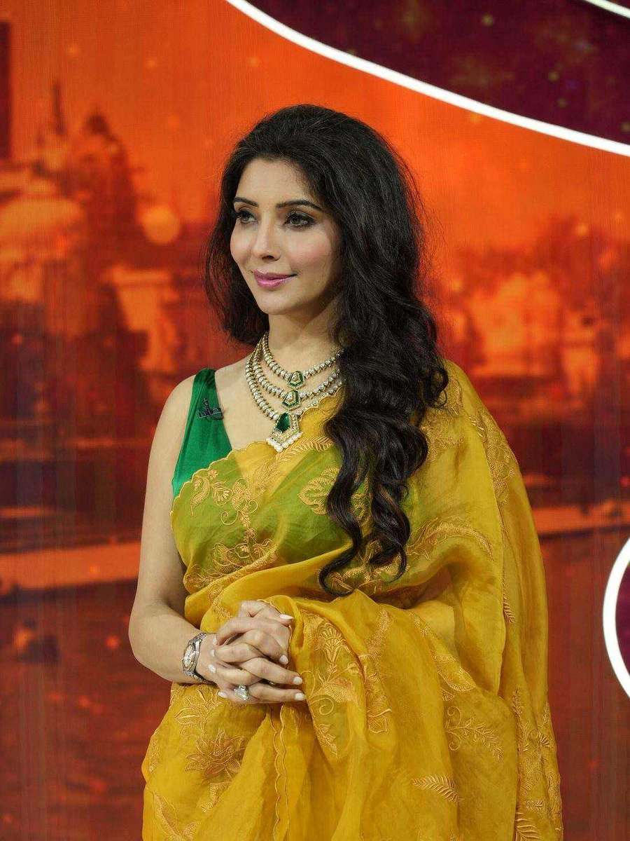 Dr. Jai Madaan, styled by Tanya Jain in an olive-gold saree against a warm studio backdrop