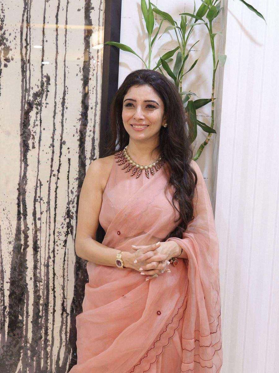 A peach saree, photographed in a pale room