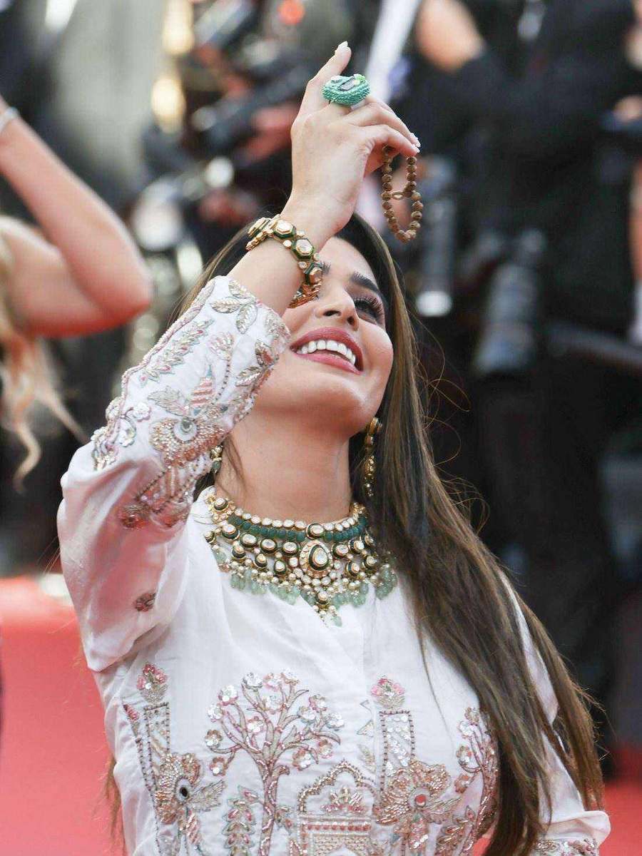 Aarti Khetarpal, styled by Tanya Jain in the same look, laughing, with the press bank behind her
