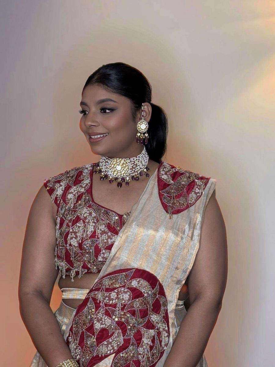 Tanya Jain in a crimson and gold hand-embroidered blouse with a tissue drape and kundan jewellery